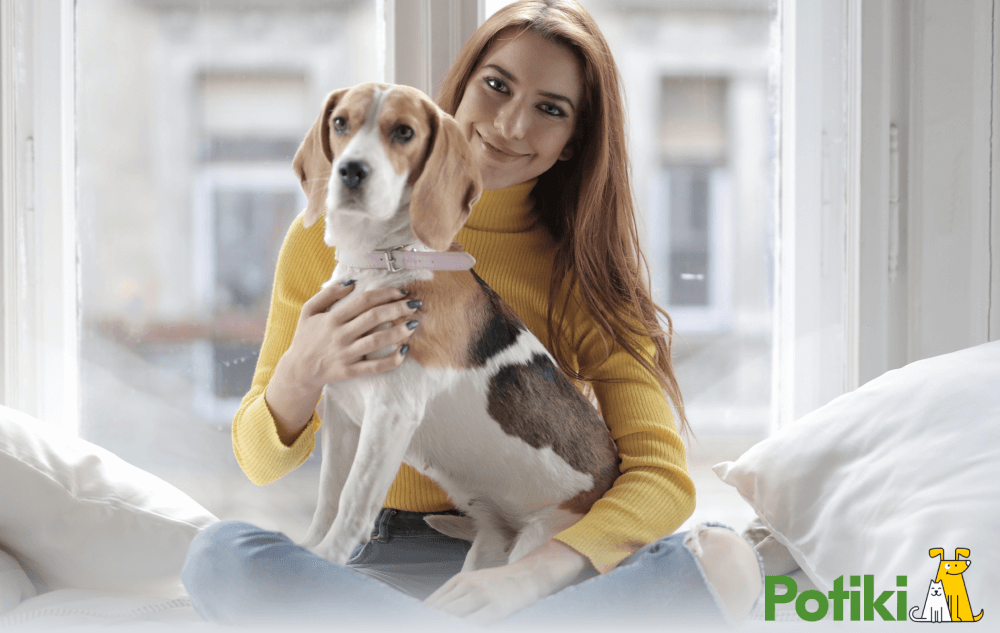 A lady holding a pet with pre exisitng condition